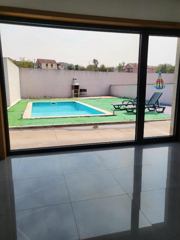 a view of a swimming pool from a window at Villa Machado Chaves in Vila Nova da Veiga