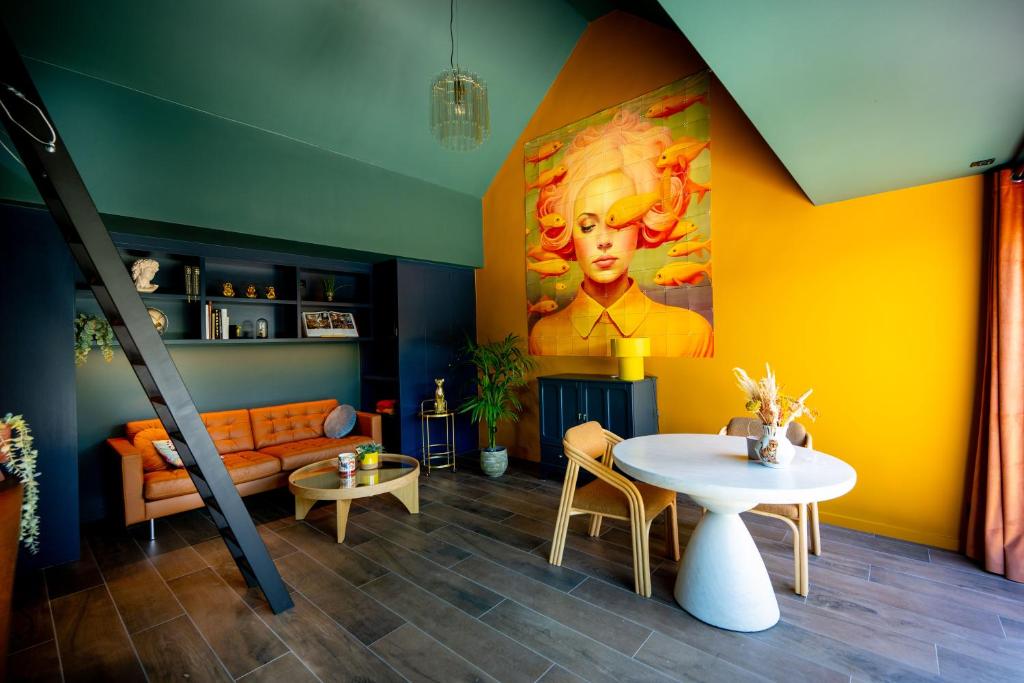 a living room with a couch and a table at NEW - Dicht bij de zee en Brugge in De Haan