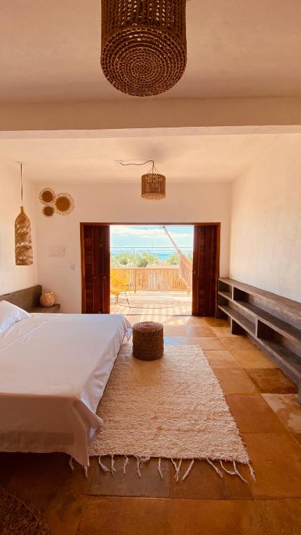 a bedroom with a bed and a view of the ocean at Casa Tartaruga Emboaca Trairí in Trairi