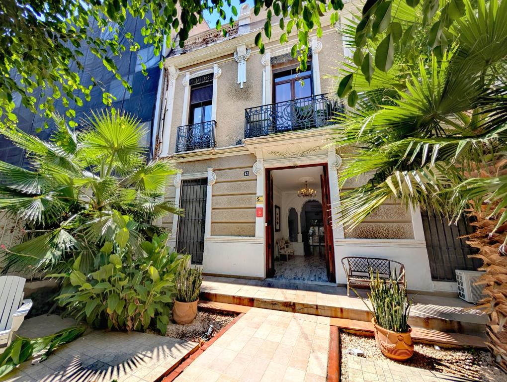 a building with a door and some palm trees at Portrait Boutique Villa in Valencia