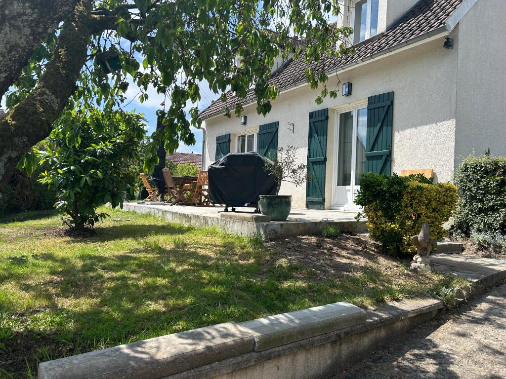 a house with a yard with a couch on the porch at La résidence du domaine Apremont in Apremont
