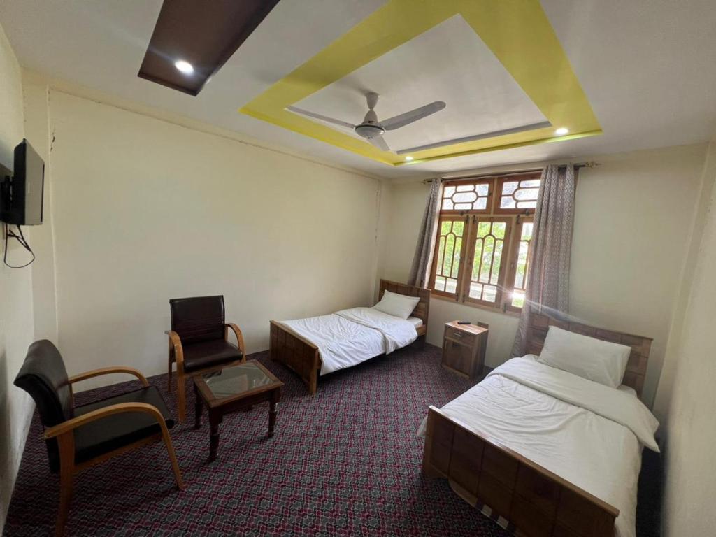 Ένα ή περισσότερα κρεβάτια σε δωμάτιο στο Yasin Heaven Star Hotel