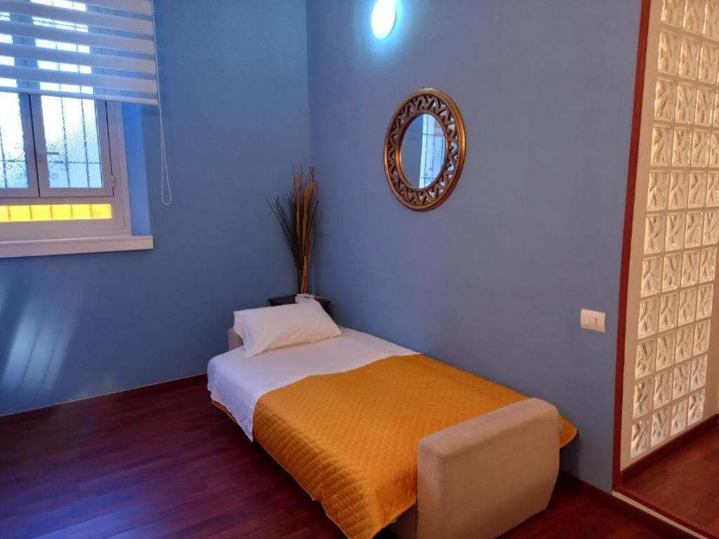 a bedroom with a bed with a mirror on the wall at Allianz Mico Trade Fair nearby - ARENA SUITE ALL COMFORTS - citycentre outside of ZTL with FREE SECURE PARKING GARAGE - Free wi fi - subway Moscova GREEN LINE few minutes by walk in Milan