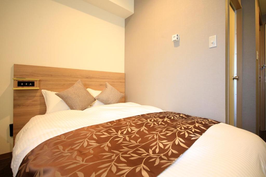 Postel nebo postele na pokoji v ubytování Hotel Sunshine Utsunomiya