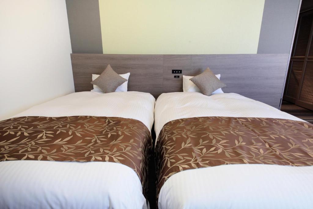 Postel nebo postele na pokoji v ubytování Hotel Sunshine Utsunomiya