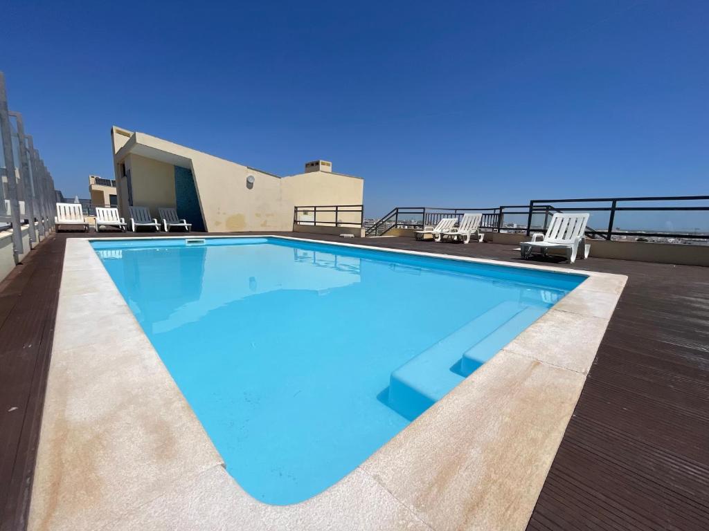 a large swimming pool on the roof of a building at Casa Custodio in Olhão