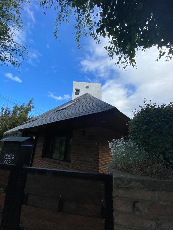 a black roof on a brick house with a gate at Alojamiento centro Bariloche in San Carlos de Bariloche