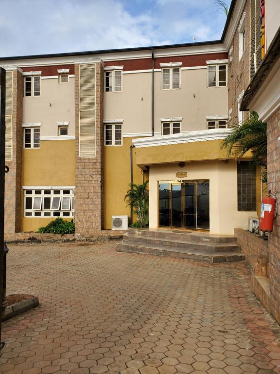 an empty parking lot in front of a building at Romeo Suites & Apartment in Ipaja