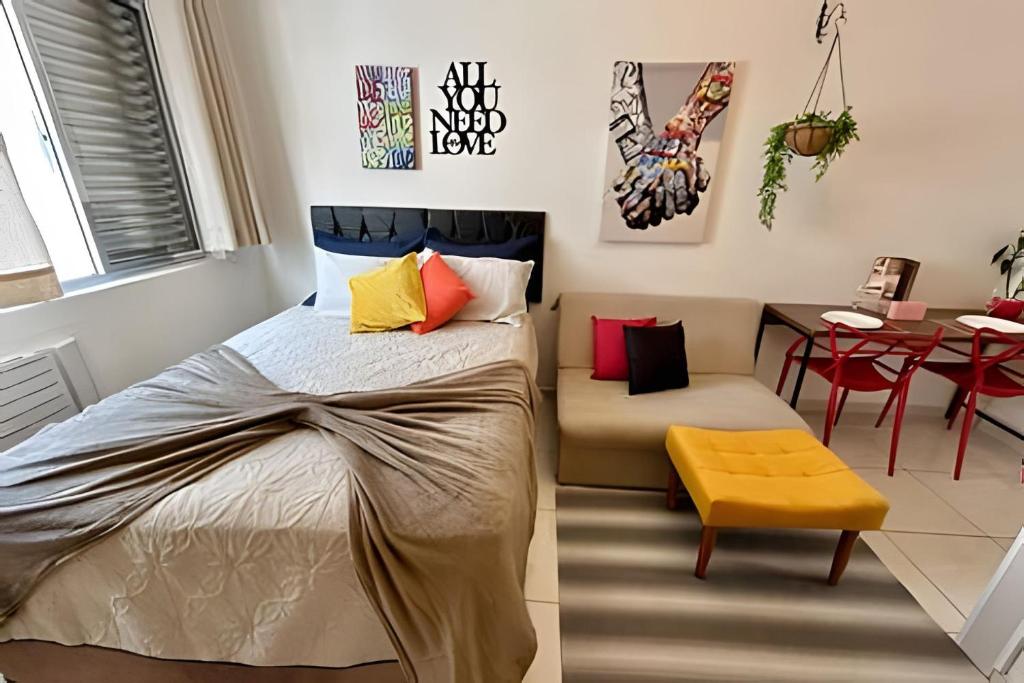 a bedroom with a bed and a table and chairs at SHB - Studio in the Heart of Gonzaga by the Sea in Santos