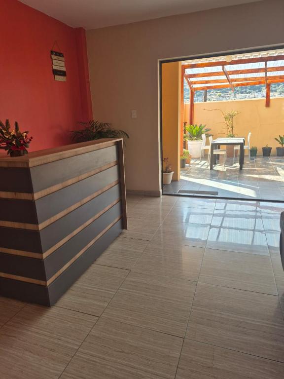 a lobby with a counter and a view of a patio at Jate Guest House in Maseru