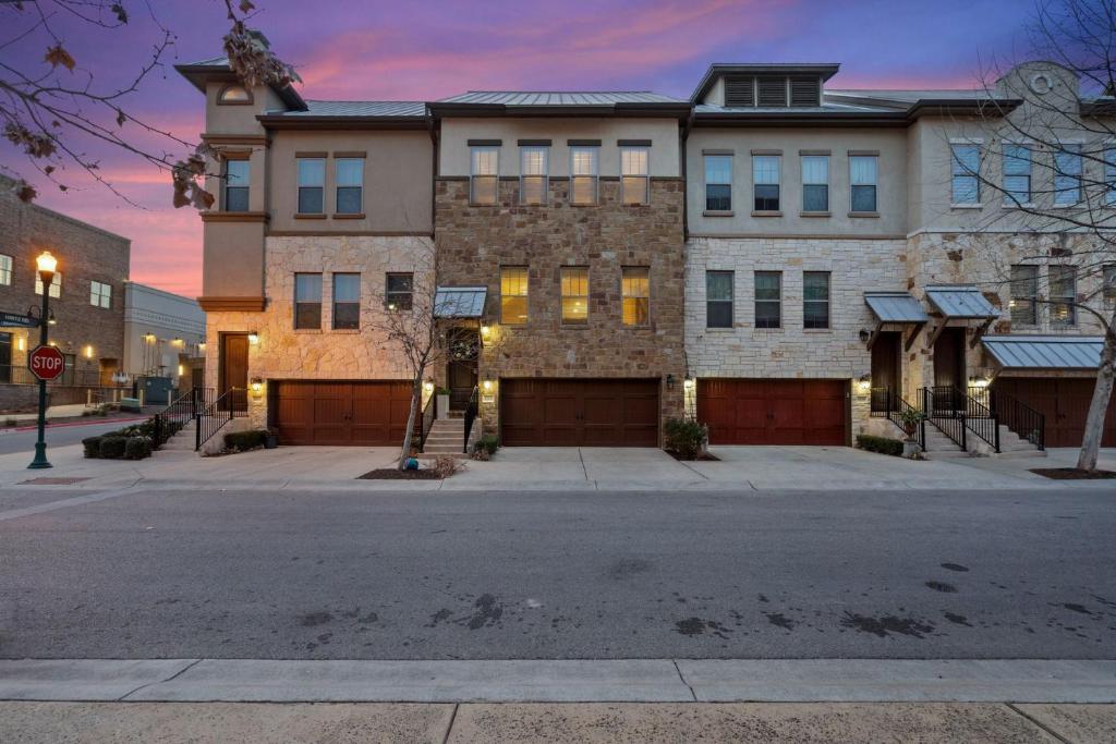 a large building on a street with a stop sign at Modern Luxury Townhouse with Private Elevator and Rooftop Terrace in Georgetown