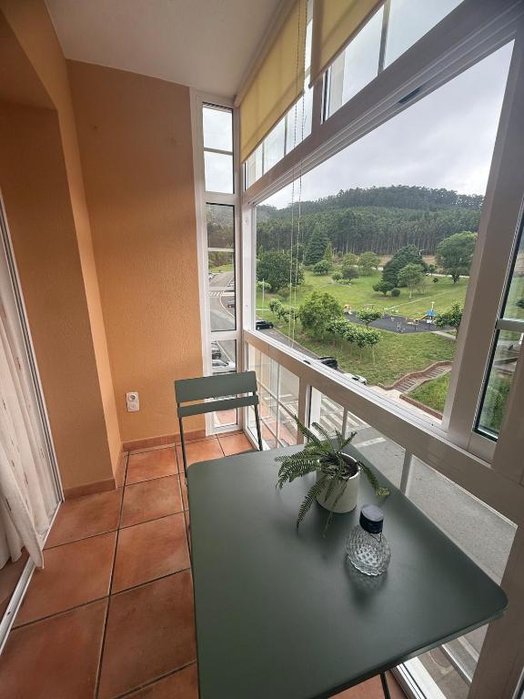 a room with a table and a large window at Apartmento en Xove in Jove