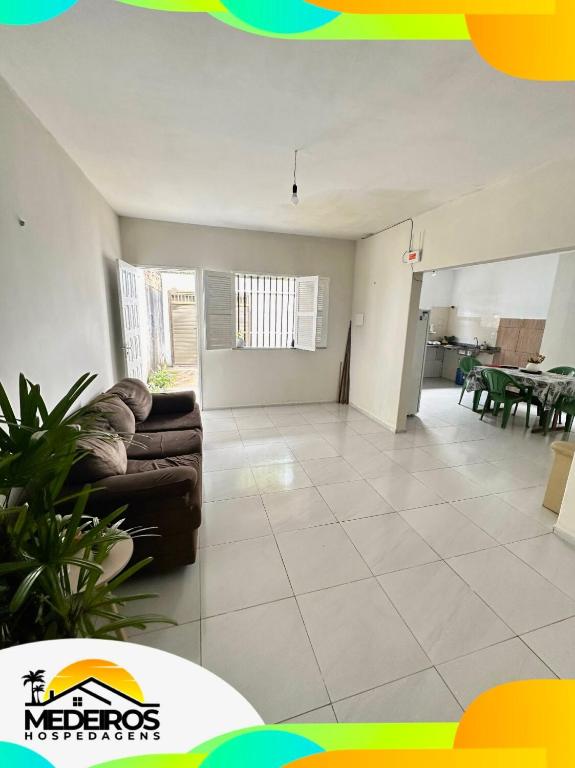 a living room with a couch and a table at Casa próxima à litorânea! in São Luís
