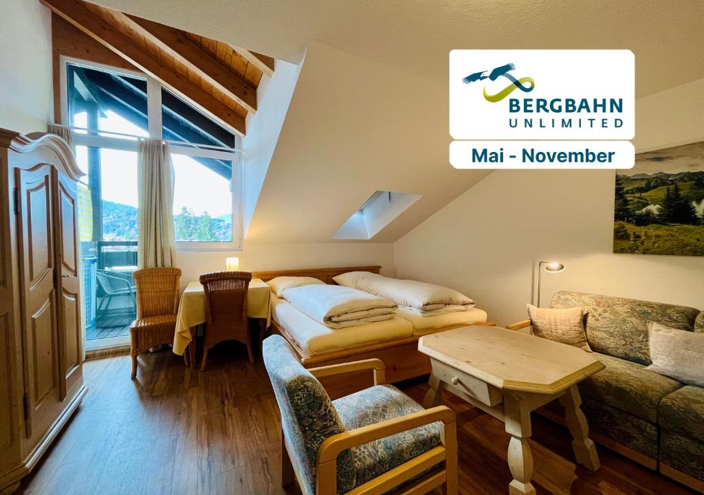 a hotel room with a bed and a couch at Zickenstüble B19 Montana Haus in Oberstdorf