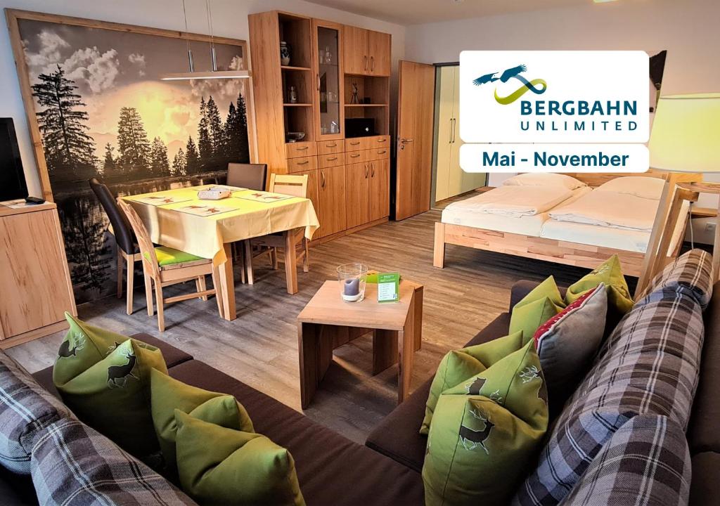 a living room with a couch and a table at Montana Haus, Fewo A14, A17, B4 oder C8 in Oberstdorf
