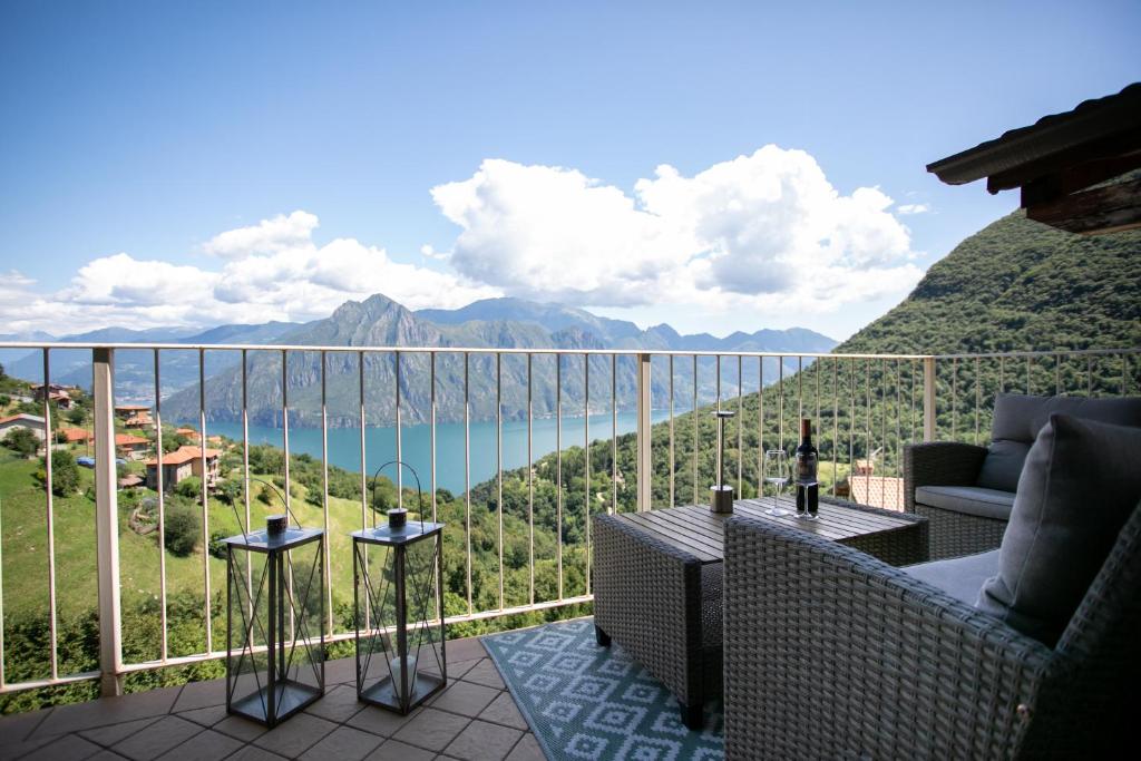 a balcony with a view of the water and mountains at L'angolo di Fonteno in Fonteno