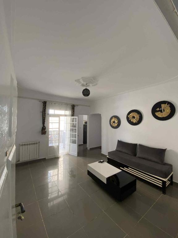 a living room with a couch and a table at Dany house in 'Aïn el Turk