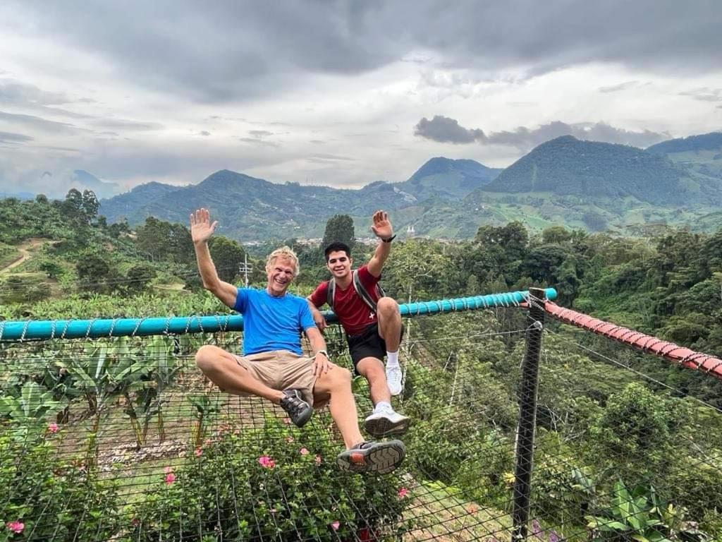 two people sitting on a monkey bar on a mountain at Apartamento Privado en Jardin, Programación de Tours y Mas in Jardin