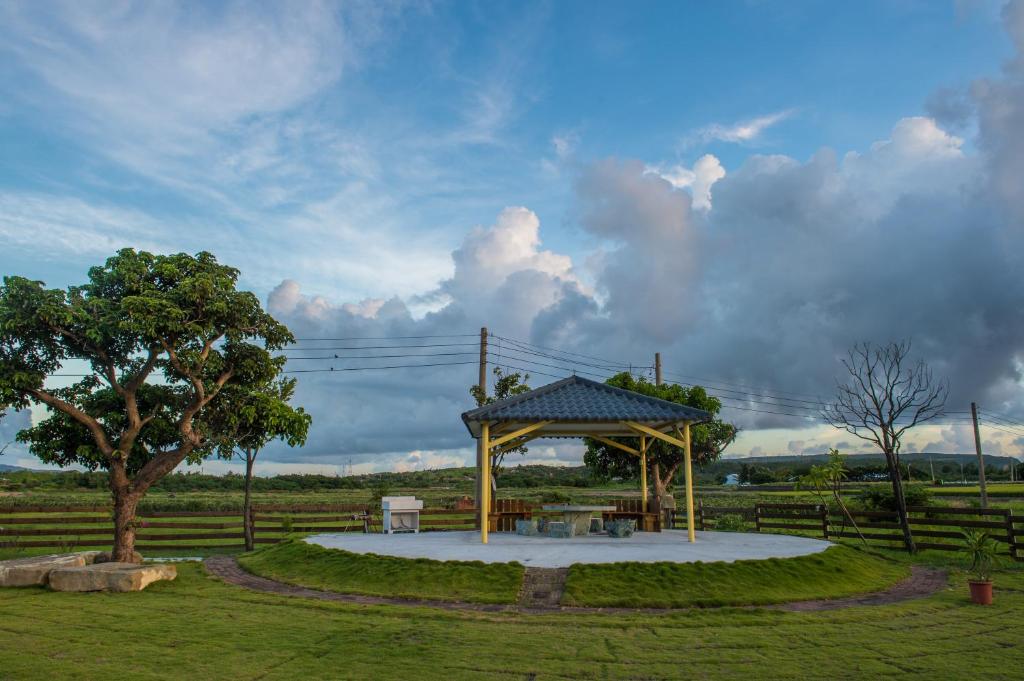 a gazebo with a picnic table in a park at Country Lane in Checheng