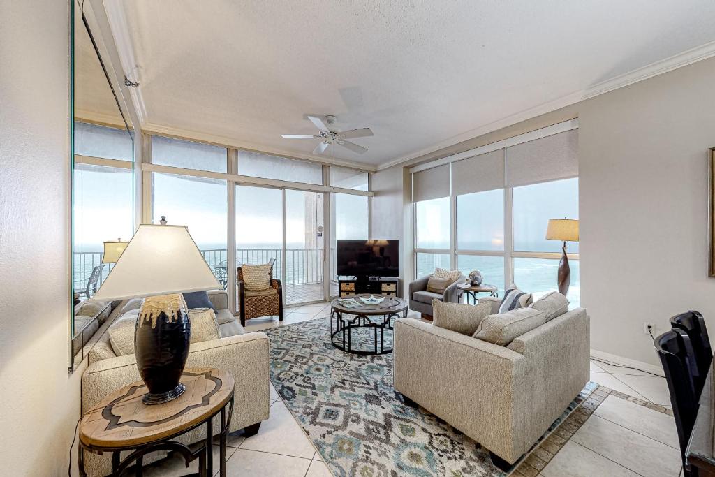 a living room with a couch and chairs and a television at Hidden Dunes 1706 in Destin