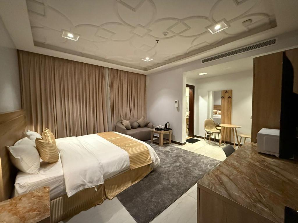a hotel room with a bed and a living room at راحة ترف Chicnest in Jeddah
