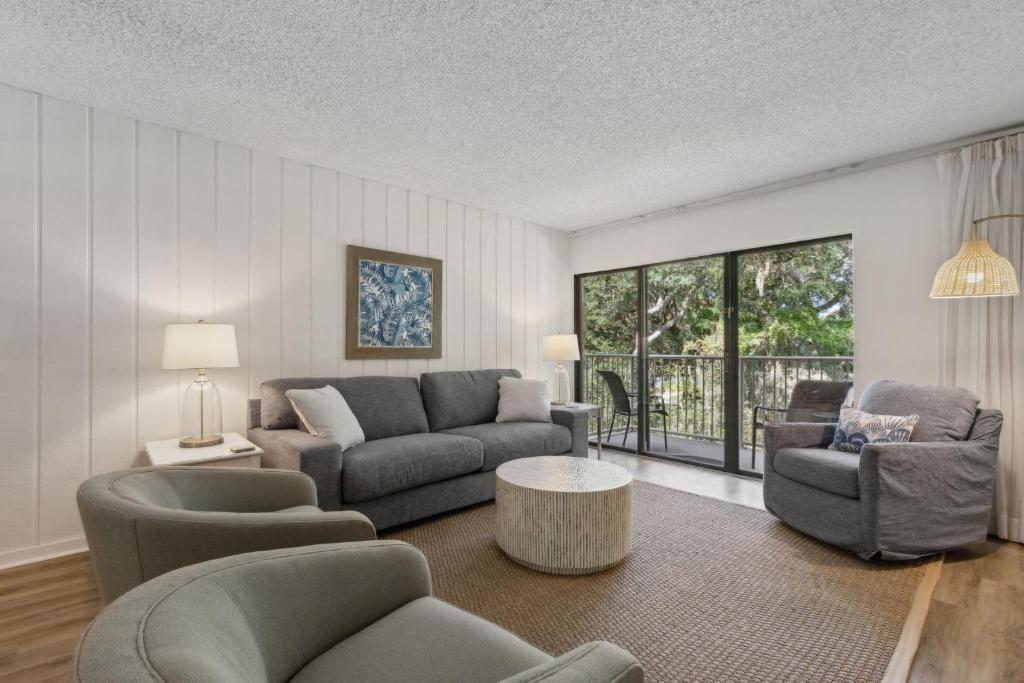 a living room with a couch and chairs at 2112 Beach Wood in Amelia Island