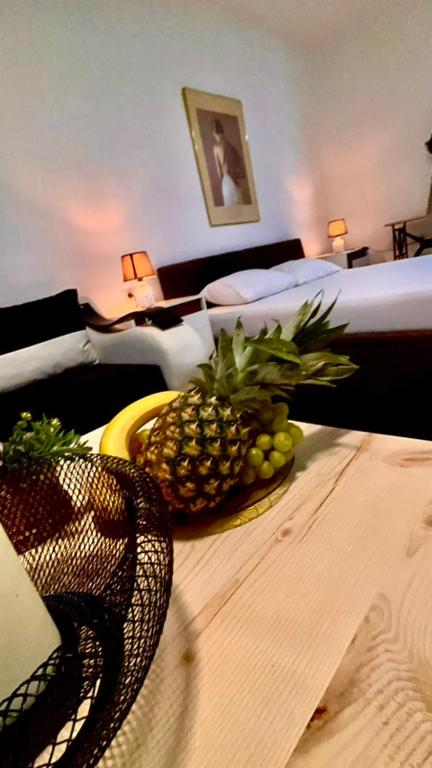 a pineapple on a table in a hotel room at Villa Srna Apartments in Brazda
