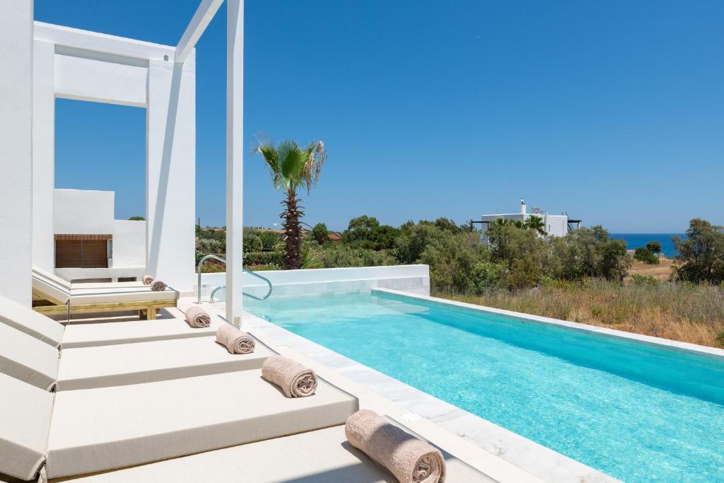 a villa with a swimming pool with a view at Sealove Villa in Lachania