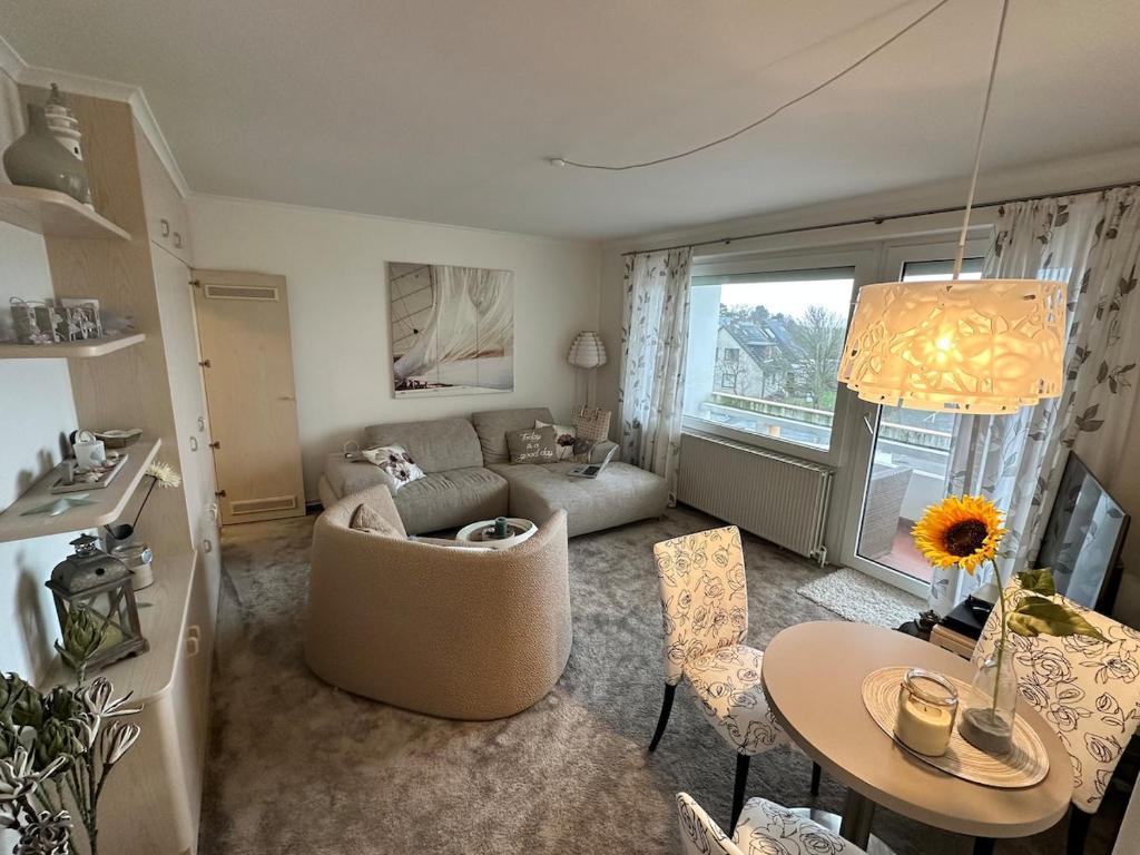 a living room with a couch and a table at Modern, Gemütlich, Strandnah in Cuxhaven
