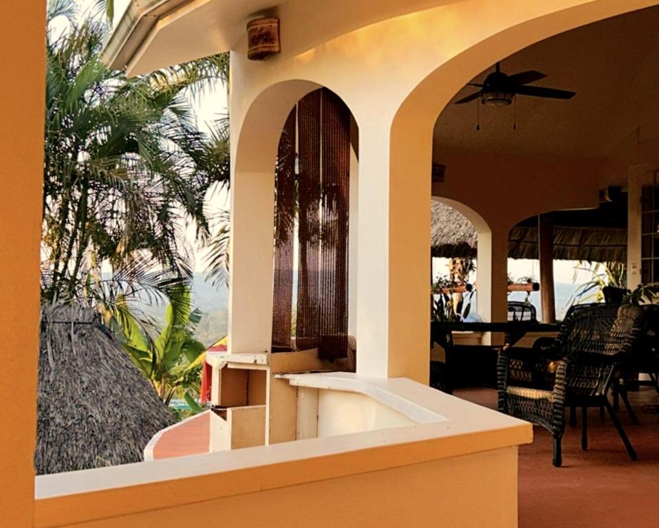 a room with a building with a table and chairs at Birders' Paradise with Private Pool & Epic Views in Santa Elena