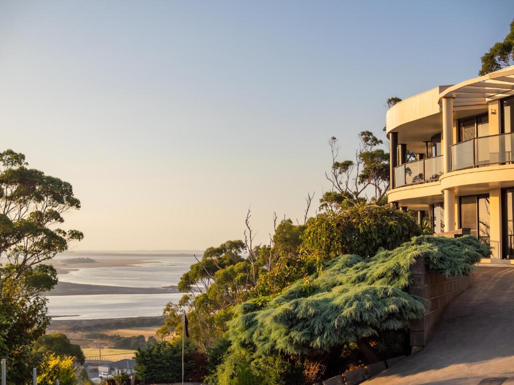 a house on a hill with a view of the ocean at Sheer Pleasure Accommodation in Smithton