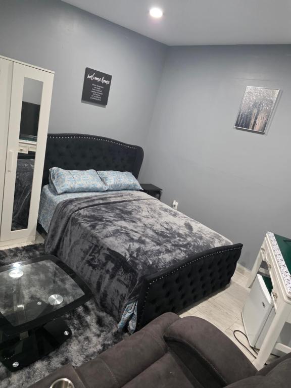 a bedroom with a bed and a couch at Newly built Studio Close to NYC and EWR in Irvington