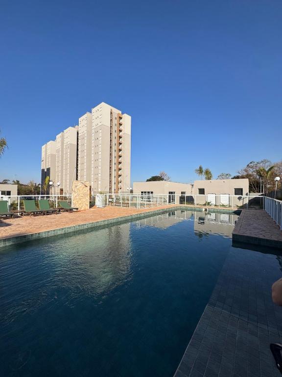 a large pool of water with buildings in the background at Apartamento em Barretos in Barretos