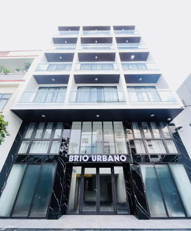 a building with a sign on the front of it at BRIO Urbano Apartment in Danang