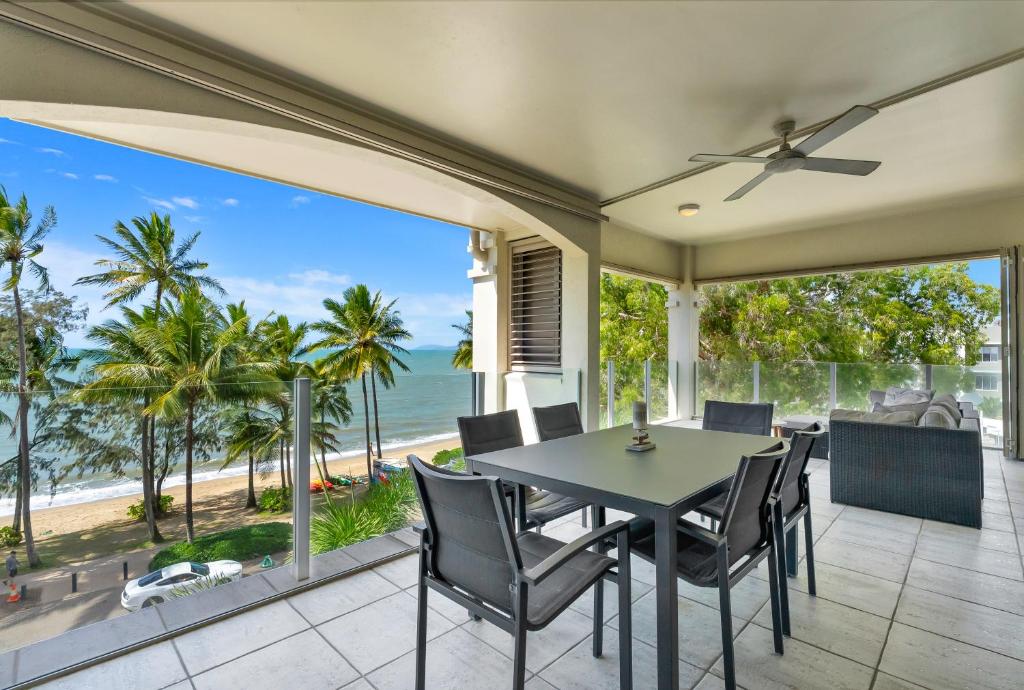 a dining room with a table and a view of the ocean at The Marron Bloom - Beachfront Boutique Bliss in Palm Cove