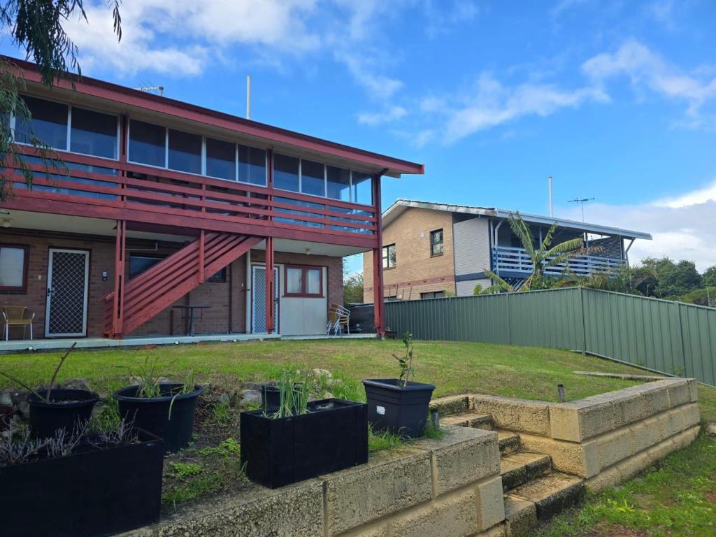 a house with potted plants in front of it at Double View in Lancelin