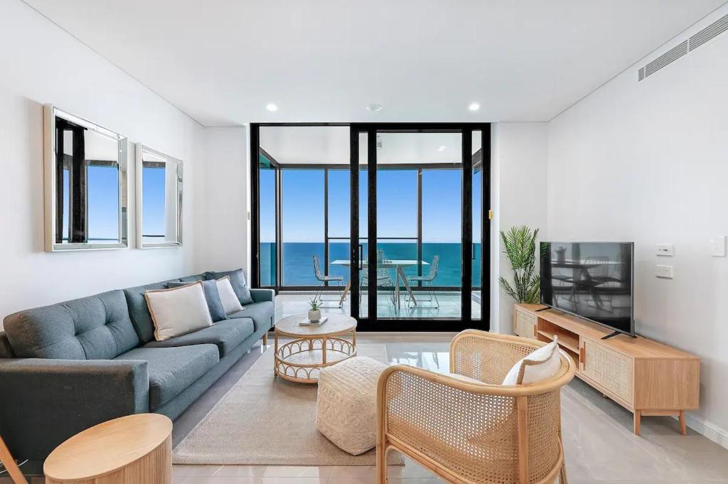 a living room with a couch and a table at Sky-High Villa with Wide Ocean Views - Pet Friendly in Gold Coast