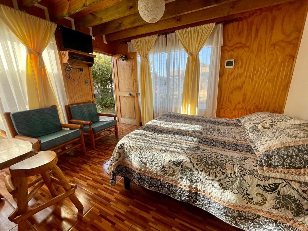 une chambre avec un lit, une chaise et une fenêtre dans l'établissement Hermoso departamento en sector Playa Hermosa Pichilemu - Cabañas Parova, à Pichilemu