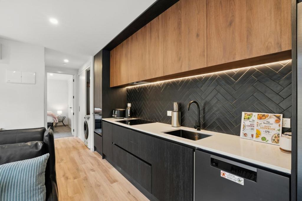 a kitchen with a sink and a counter top at Mountain Escape by Remarkables 9 | 2-bedroom unit in Frankton Wharf