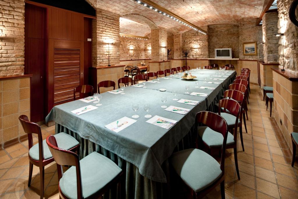 a large long table in a large room with chairs at Hotel Rialto in Barcelona