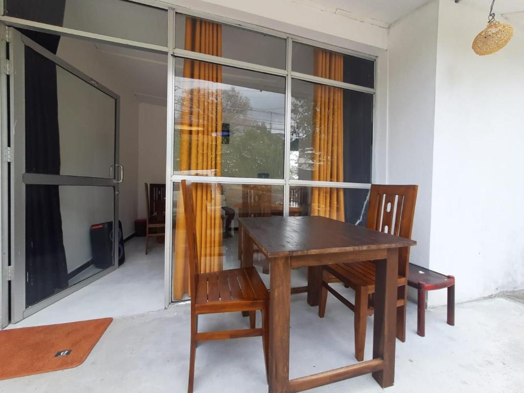 a dining room with a wooden table and chairs at Golden Waters Stay & Dine in Norwood
