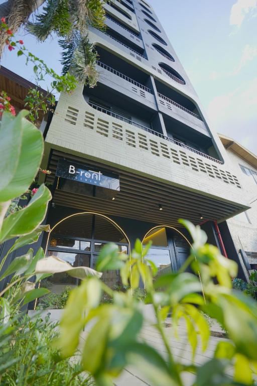 a tall building with a sign in front of it at BRENT 30 Living in Medellín