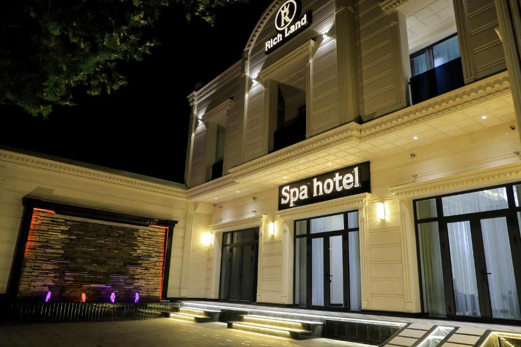 サマルカンドにあるRich Land Hotelのスパホテルの看板が書かれた建物