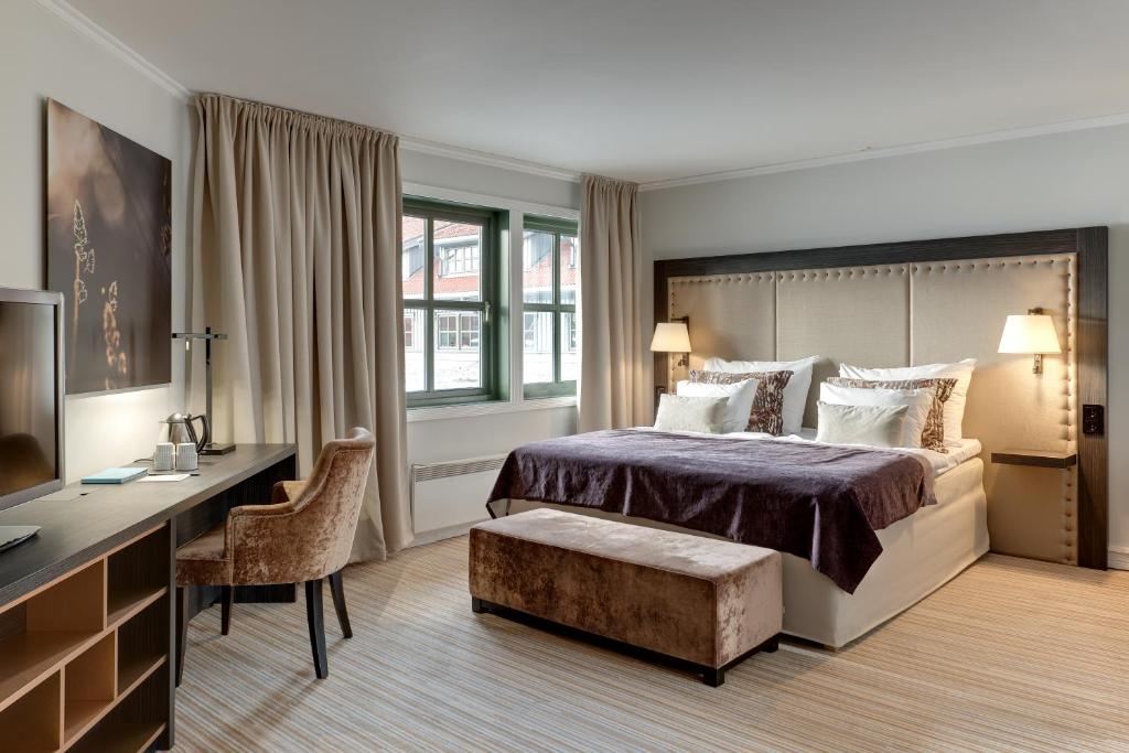 a hotel room with a bed and a desk and a computer at Clarion Hotel Oslo Airport in Gardermoen