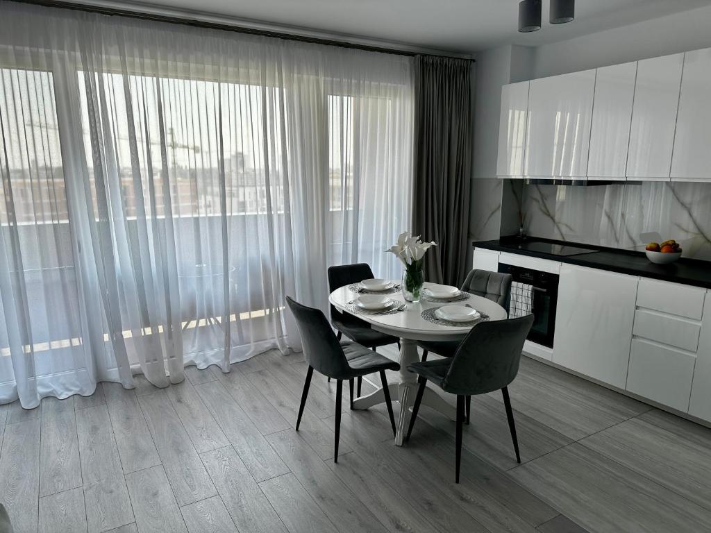 a dining room with a table and chairs in a kitchen at Great View & Parking - Harmony Premium Residence in Timişoara