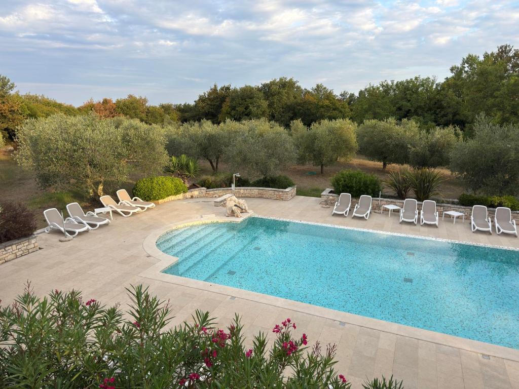 a swimming pool with lounge chairs and a swimming pool at Relais Borgo San Nicolò in Umag