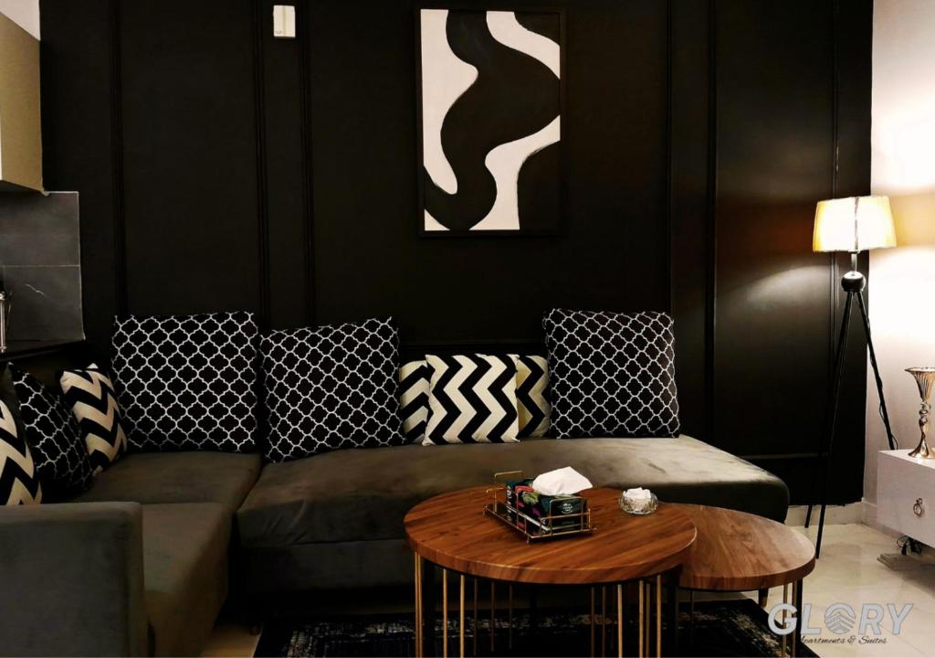 a living room with a couch and a table at 1-BHK Designer Black at Zameen Opal in Lahore