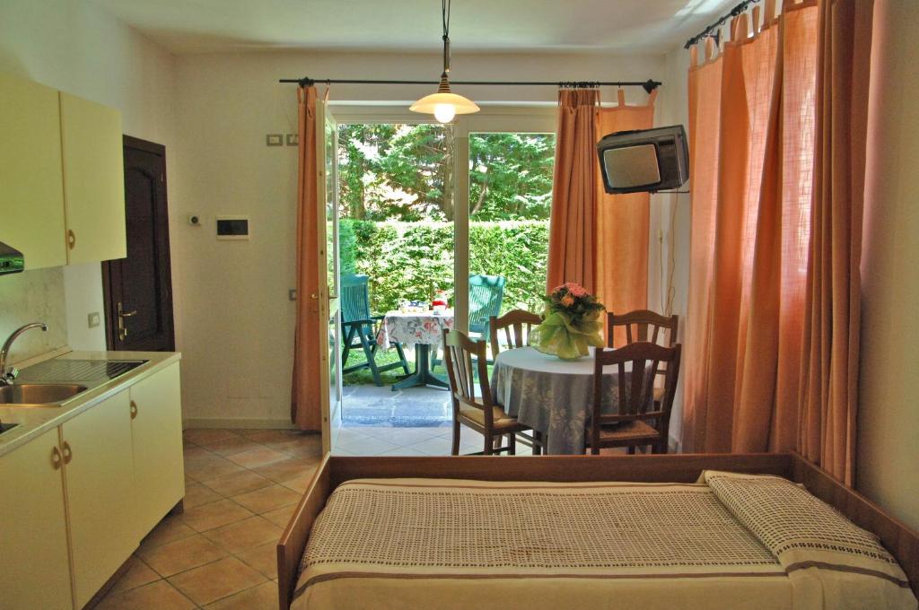 a room with a kitchen and a table with a dining room at Residence Garden in Cannobio