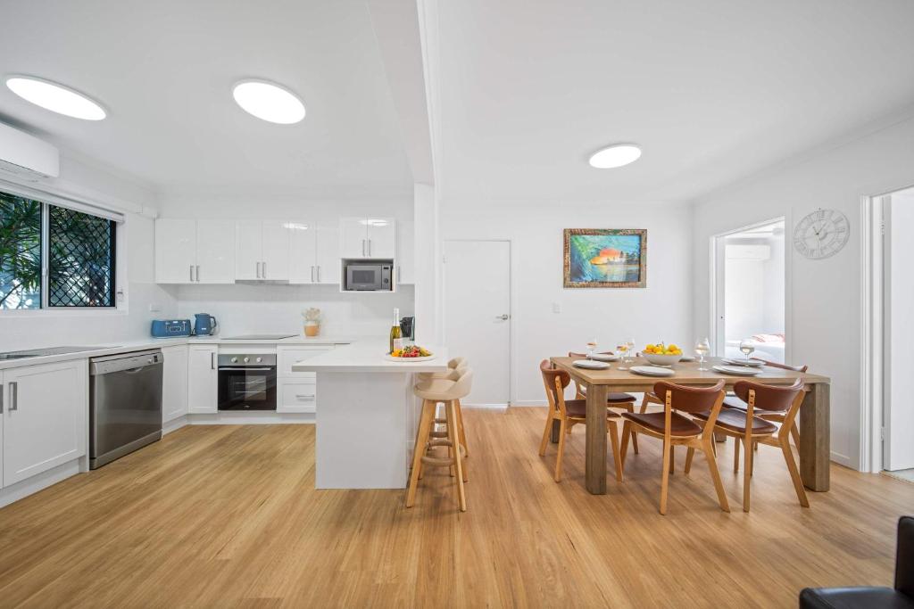 a kitchen and dining room with a table and chairs at The Palms in Coolum Beach - Unit B in Coolum Beach