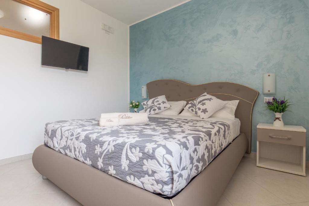 Łóżko lub łóżka w pokoju w obiekcie B&B Paradiso